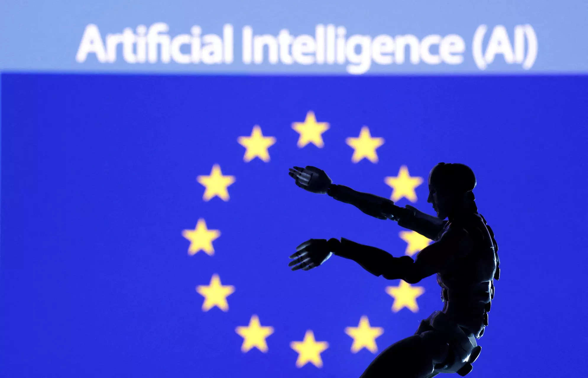 FILE PHOTO: Illustration shows AI Artificial intelligence words, miniature of robot and EU flag